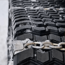 Madison Machinery Inc Grizzly™ Chains for Tracks | Skid Steer Rubber Track Traction System